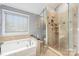 Spa-like bathroom with a large shower and a soaking tub at 3903 Bon Rea Dr, Charlotte, NC 28226