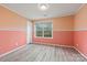 Simple bedroom with coral walls and wood-look flooring at 3903 Bon Rea Dr, Charlotte, NC 28226