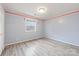 Cozy bedroom with light grey walls and wood-look flooring at 3903 Bon Rea Dr, Charlotte, NC 28226