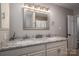 Double vanity bathroom with granite countertop and a large mirror at 401 Kenwood Ave, Cherryville, NC 28021