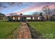 Charming brick home with a manicured lawn and inviting entrance, perfect for a cozy Gathering lifestyle at 401 Kenwood Ave, Cherryville, NC 28021