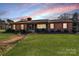 Charming brick home with a manicured lawn and inviting entrance, perfect for a cozy Gathering lifestyle at 401 Kenwood Ave, Cherryville, NC 28021