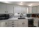 Bright kitchen with white cabinets, granite counters, and modern appliances at 401 Kenwood Ave, Cherryville, NC 28021