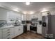 Updated kitchen featuring white cabinets and a stylish backsplash at 401 Kenwood Ave, Cherryville, NC 28021