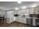 Eat-in kitchen with white cabinets, granite counters, and wood floors at 401 Kenwood Ave, Cherryville, NC 28021