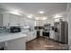 Modern kitchen with white cabinets and stainless steel appliances at 401 Kenwood Ave, Cherryville, NC 28021