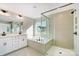 Elegant bathroom with double vanity, soaking tub, and shower at 5036 Heathland Dr # 71, Charlotte, NC 28215