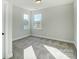 Bright bedroom with carpet flooring and two windows at 5036 Heathland Dr # 71, Charlotte, NC 28215