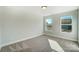 Well-lit bedroom with two windows and carpeted floor at 5036 Heathland Dr # 71, Charlotte, NC 28215