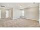 Well-lit bedroom with carpet flooring and access to hallway at 5036 Heathland Dr # 71, Charlotte, NC 28215