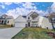 Two-story house with white siding, stone accents, and a two-car garage at 5036 Heathland Dr # 71, Charlotte, NC 28215