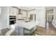 Modern kitchen with white cabinets, large island, and stainless steel appliances at 5036 Heathland Dr # 71, Charlotte, NC 28215