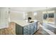 Modern kitchen with white cabinets, island, and stainless steel appliances at 5036 Heathland Dr # 71, Charlotte, NC 28215