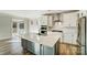 Modern kitchen with white cabinets, a large island, and stainless steel appliances at 5036 Heathland Dr # 71, Charlotte, NC 28215