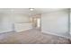 Open loft with carpet, neutral walls, and hallway access at 5036 Heathland Dr # 71, Charlotte, NC 28215