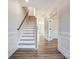 Elegant staircase with wood and white risers in a bright hallway at 5036 Heathland Dr # 71, Charlotte, NC 28215