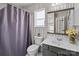 Bathroom with a shower/tub, gray vanity, and patterned wallpaper at 505 Viking Sw Dr, Concord, NC 28025