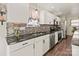 Modern kitchen with white cabinets, granite counters, and island at 505 Viking Sw Dr, Concord, NC 28025