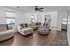 Living room featuring L-shaped sectional and wood floors at 505 Viking Sw Dr, Concord, NC 28025