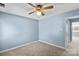 Bedroom with ceiling fan, neutral walls, and access to a hallway at 5190 Corbin Ln, Hickory, NC 28601