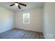 Bright bedroom with wood-look floors and a window offering natural light at 5966 Quarter Mile Rd # 2, Clover, SC 29710