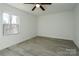 Bright bedroom with ceiling fan and gray vinyl flooring at 5966 Quarter Mile Rd # 2, Clover, SC 29710