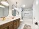 Modern bathroom with double sinks, oval mirrors, and a bathtub at 604 N Providence St, Waxhaw, NC 28173