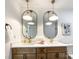 Modern bathroom with double sinks, oval mirrors, and light wood cabinets at 604 N Providence St, Waxhaw, NC 28173