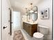 Modern bathroom with double sinks, oval mirrors, and marble flooring at 604 N Providence St, Waxhaw, NC 28173