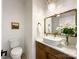 Powder room with a modern vanity and decorative mirror at 604 N Providence St, Waxhaw, NC 28173