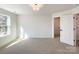 Bright bedroom with carpet, large window, and walk-in closet at 604 N Providence St, Waxhaw, NC 28173