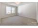 Well-lit bedroom with neutral walls and carpet flooring at 604 N Providence St, Waxhaw, NC 28173