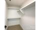 Bright walk-in closet with white shelves and a white interior at 604 N Providence St, Waxhaw, NC 28173