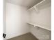 Spacious walk-in closet with built-in shelves at 604 N Providence St, Waxhaw, NC 28173