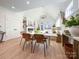 Light-filled dining area with a modern white table and wicker chairs at 604 N Providence St, Waxhaw, NC 28173