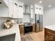 Bright kitchen featuring stainless steel appliances and light wood cabinets at 604 N Providence St, Waxhaw, NC 28173