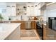 Modern kitchen with white and wood cabinets, and stainless steel appliances at 604 N Providence St, Waxhaw, NC 28173