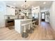 Modern kitchen with white cabinets, wood accents, and a large island at 604 N Providence St, Waxhaw, NC 28173