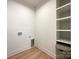 Laundry room with built-in shelving and a utility sink at 604 N Providence St, Waxhaw, NC 28173