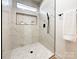 Modern shower with marble tile and built-in shelves at 604 N Providence St, Waxhaw, NC 28173