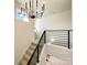 Modern staircase with metal railing and chandelier at 604 N Providence St, Waxhaw, NC 28173