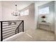 Upstairs hallway with chandelier and decorative console table at 604 N Providence St, Waxhaw, NC 28173