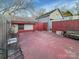 View of backyard patio including wrought-iron outdoor seating and privacy fence at 630 N Moran St, Gastonia, NC 28052