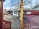 View from porch including small yard, car port, and wrought-iron outdoor seating area at 630 N Moran St, Gastonia, NC 28052