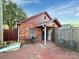 Brick home exterior showcasing a cozy porch, brick chimney, and outdoor living space at 630 N Moran St, Gastonia, NC 28052