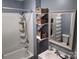 Clean bathroom with shower/tub combo and shelving at 6963 Kershaw Camden Hwy, Kershaw, SC 29067