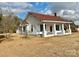 White house with red roof and a spacious front porch at 6963 Kershaw Camden Hwy, Kershaw, SC 29067