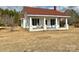 White house with red roof, front porch, and American flag at 6963 Kershaw Camden Hwy, Kershaw, SC 29067