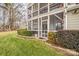 Home exterior showcasing a screened porch and landscaped yard at 7513 Mariner Cove Dr, Cornelius, NC 28031