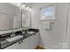 Modern bathroom with double vanity, granite countertops, and a shower/tub combo at 7620 Rolling Meadows Ln, Huntersville, NC 28078